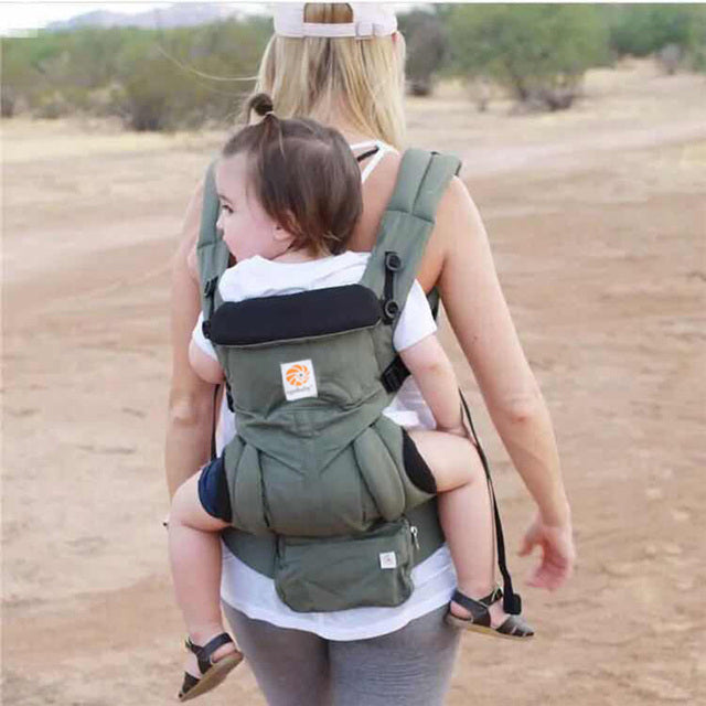 maman portant bébé porte bebe extérieur chemin semi désertique